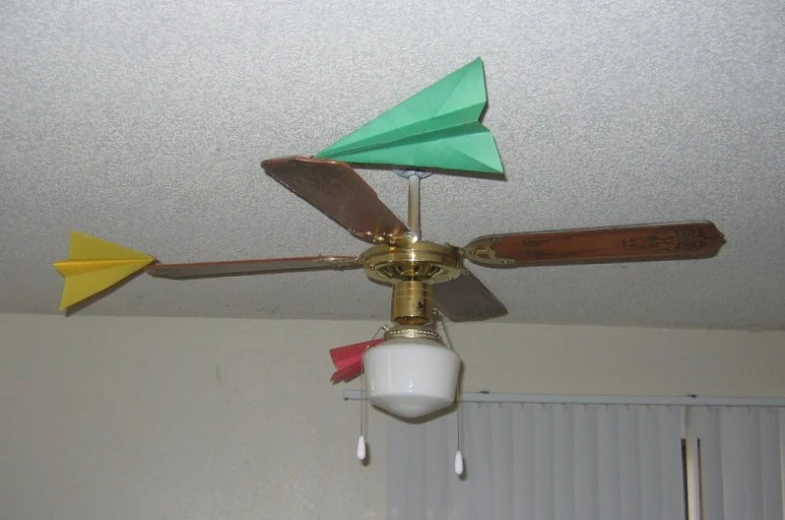 the ceiling fan has three green and yellow blades