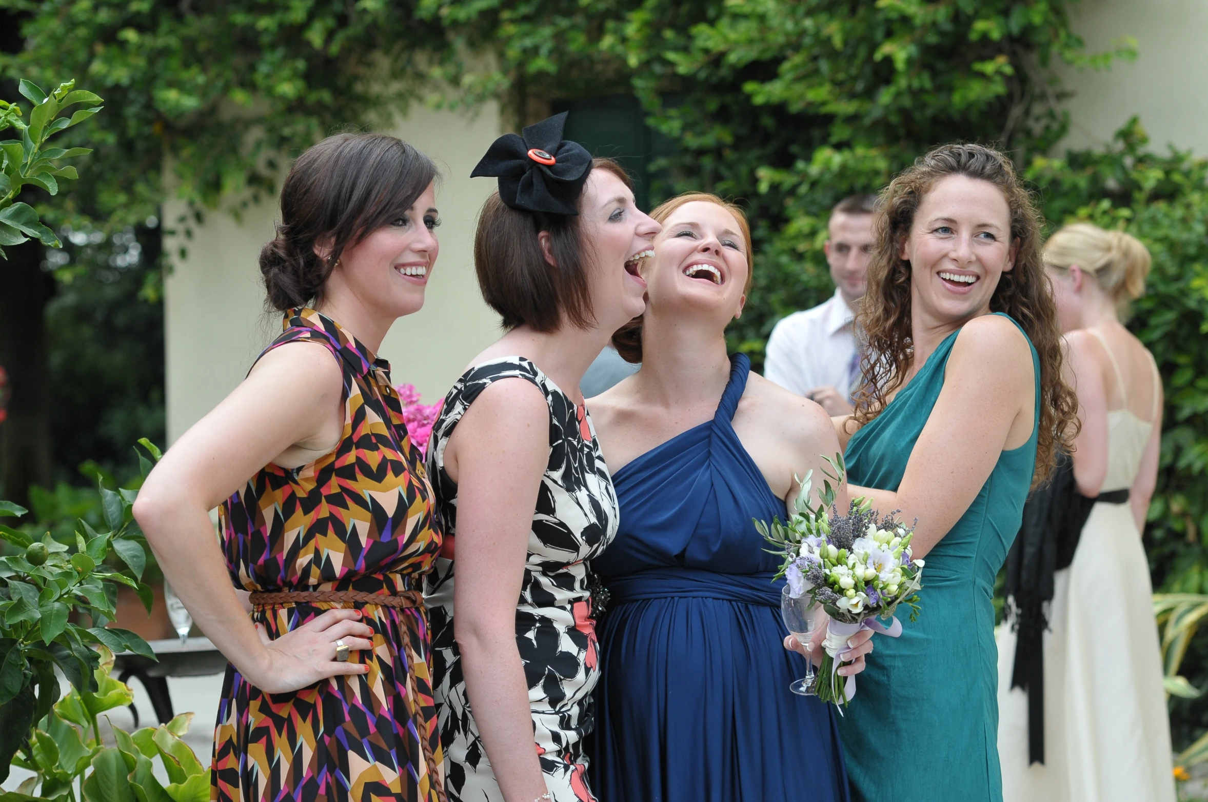 a group of women laughing together on the lawn