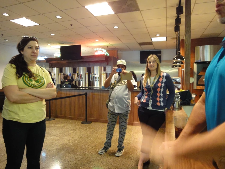 three people standing around in a bar or restaurant