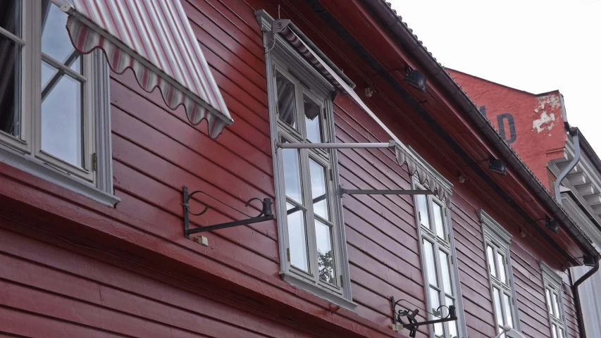 a red house with many windows and metal ckets