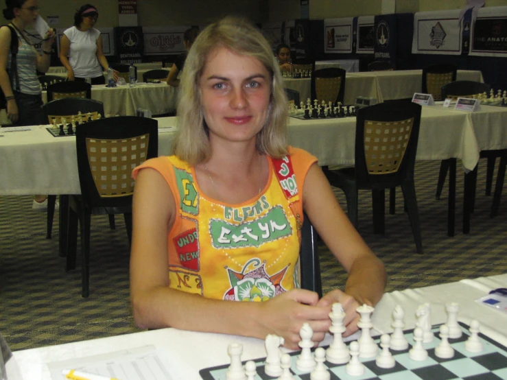 a woman playing checkers in a chess game