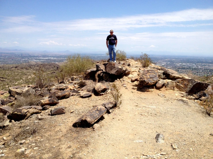 a man on top of rocks on a clear day