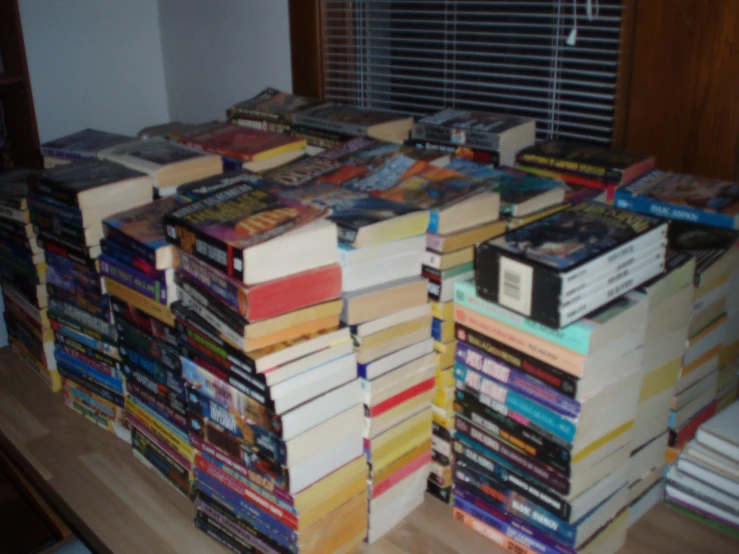 there is a large amount of books stacked on top of each other