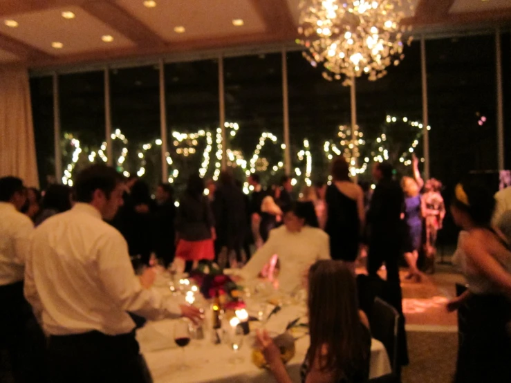 people in a large room are gathered for the evening party
