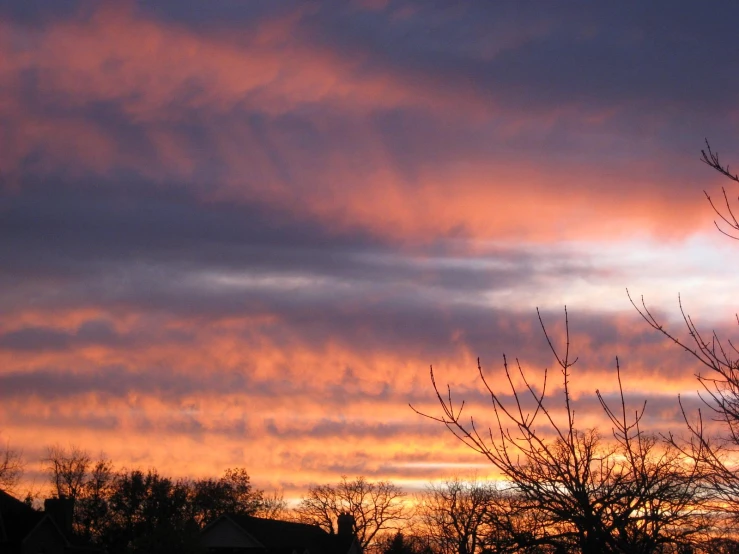 the sky is pink and orange as the sun sets