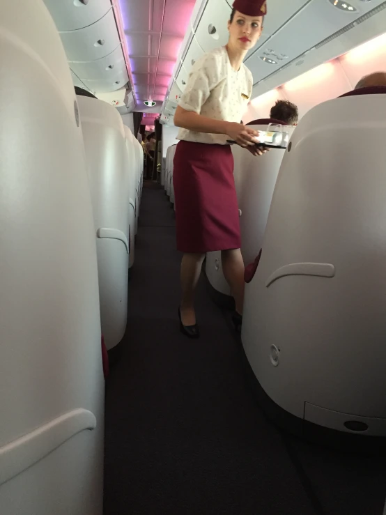 a female flight attendant displays her cake on the plane