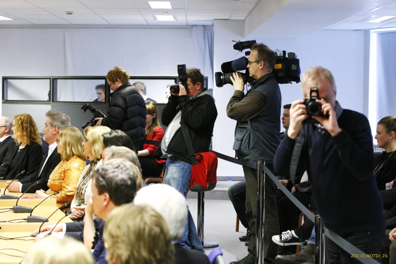 large group of people sitting in a meeting room