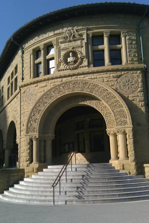 a stone building with an elaborate doorway and steps leading to it