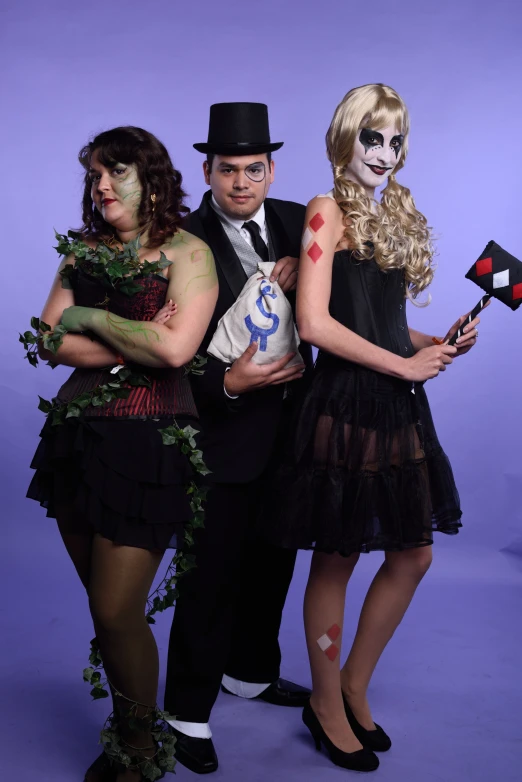 three men and women in costumes posing for a picture