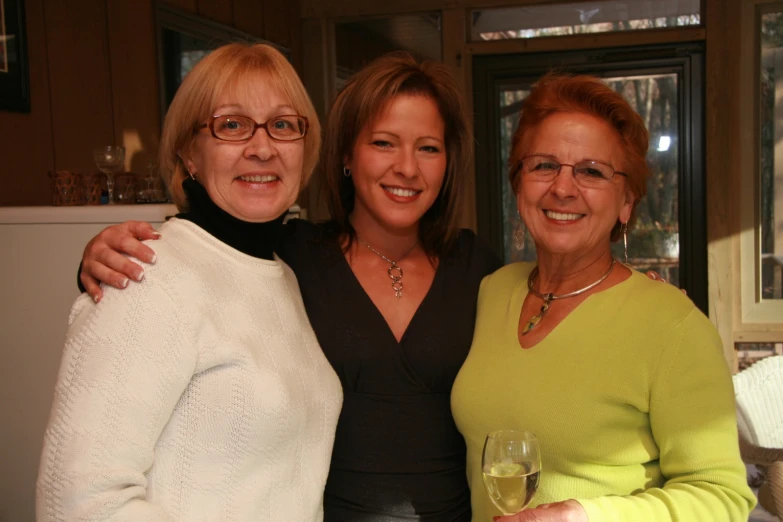 two women in the middle of a conversation with wine glasses in hand