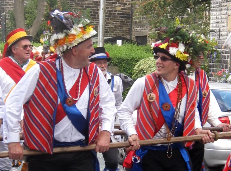 a group of people on a street with some wearing ties