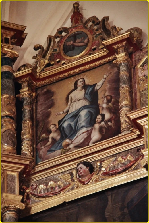 a statue with a painting above it that has images on the top