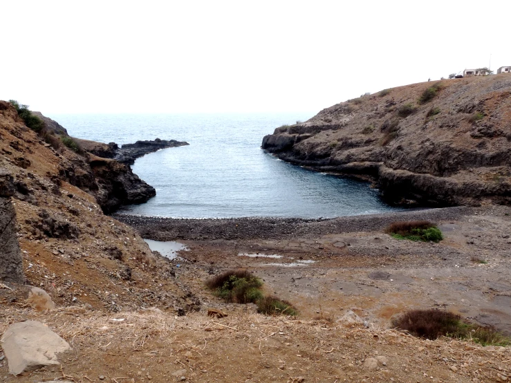 the view of the ocean from a rock cave