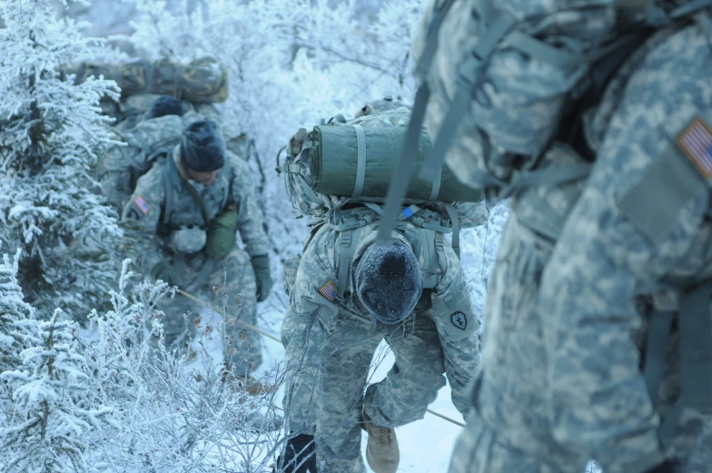 army soldiers in the woods with backpacks