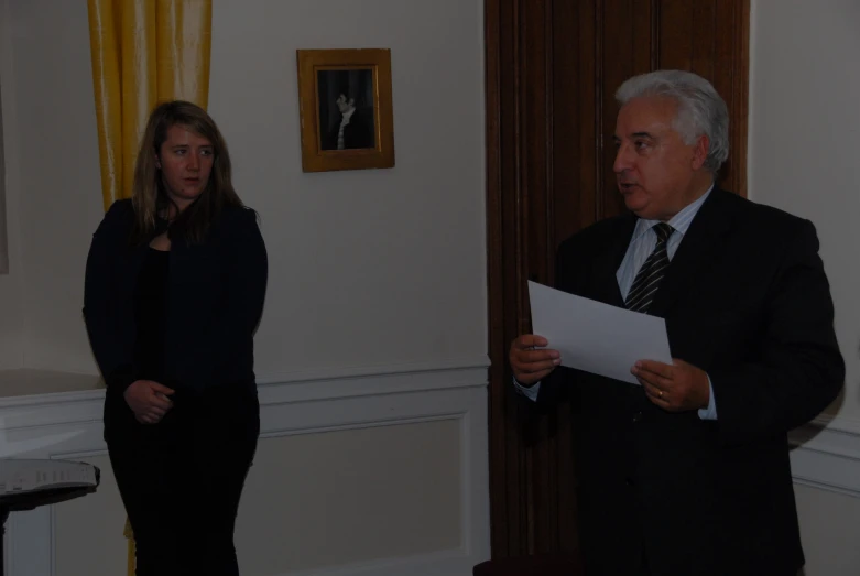 a man standing next to a woman wearing black