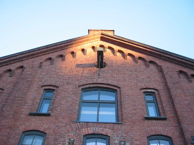 the corner of the building features a cross on one of its windows