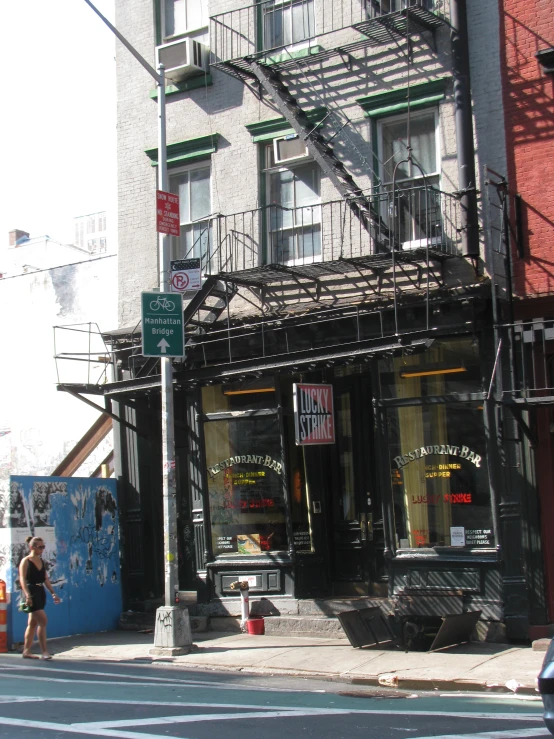 the outside of a building, with the fire escape, next to an intersection