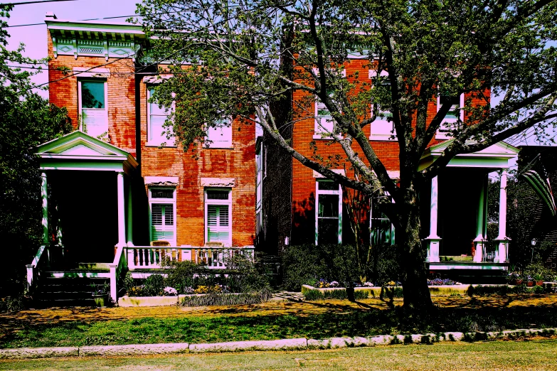 an old brick building with trees on the lawn