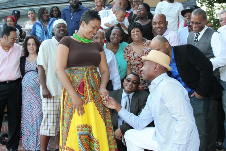 woman in brown dress giving another woman a high five