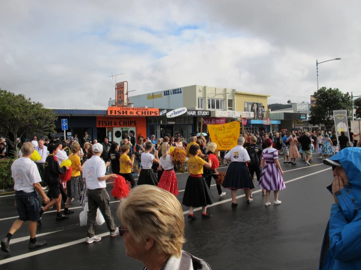 a crowd of people walking across a street