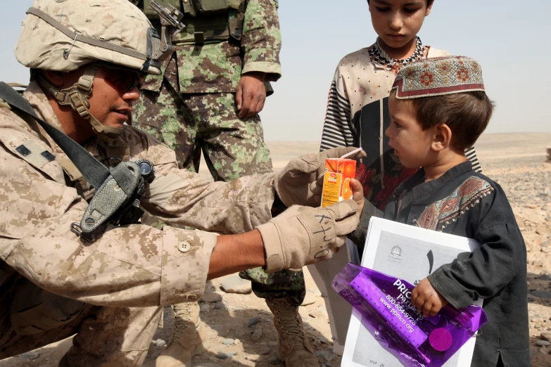 a soldier holds soing in the other hand