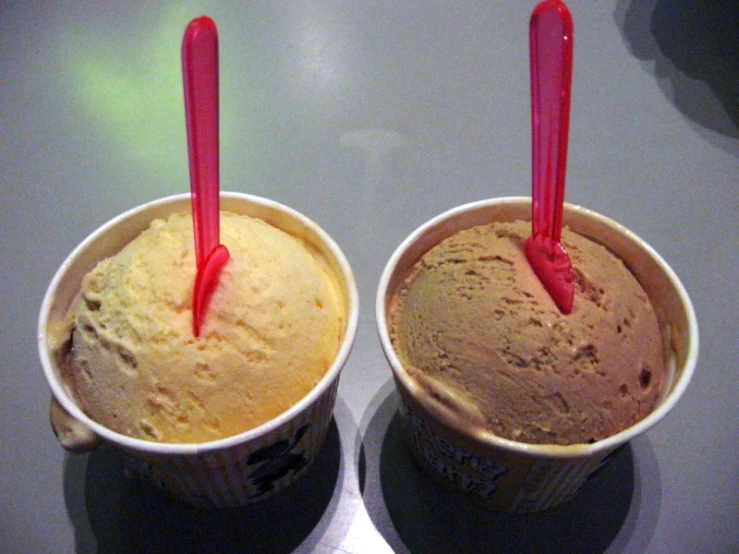 two brown cups of ice cream on table