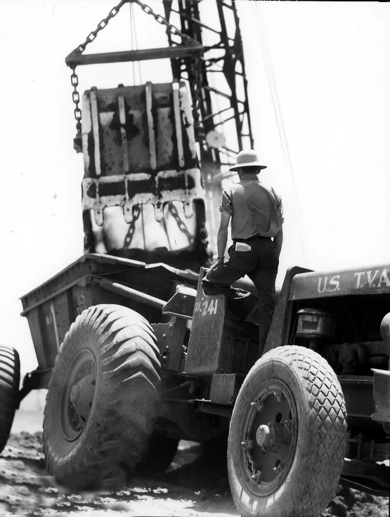 a man drives a big truck while being loaded