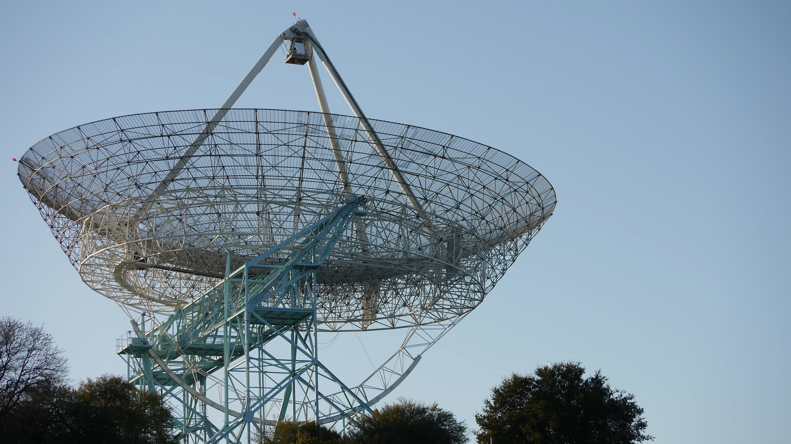 the large dish that has metal parts is hanging off of it