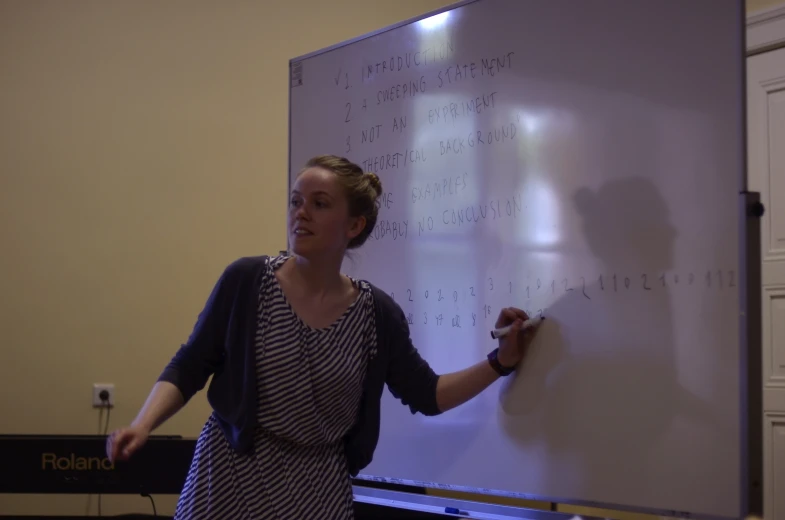 a woman is giving a presentation at the meeting