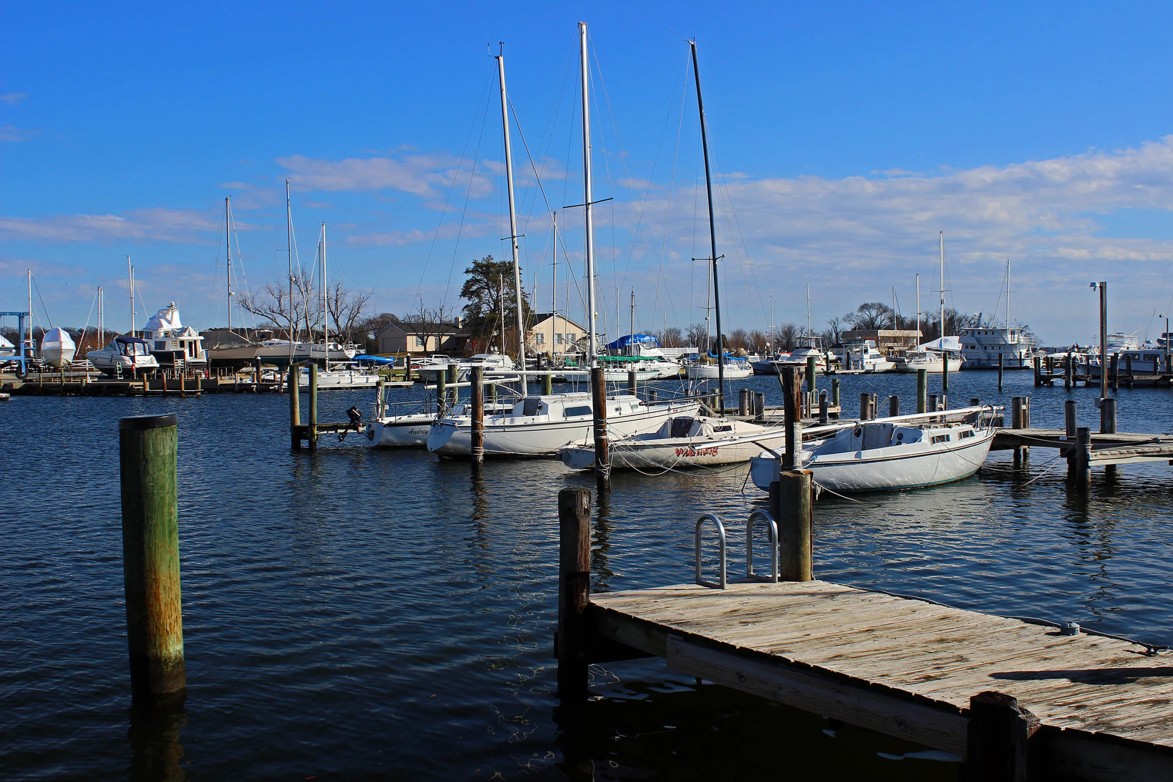 several boats sitting at a dock near some buildings