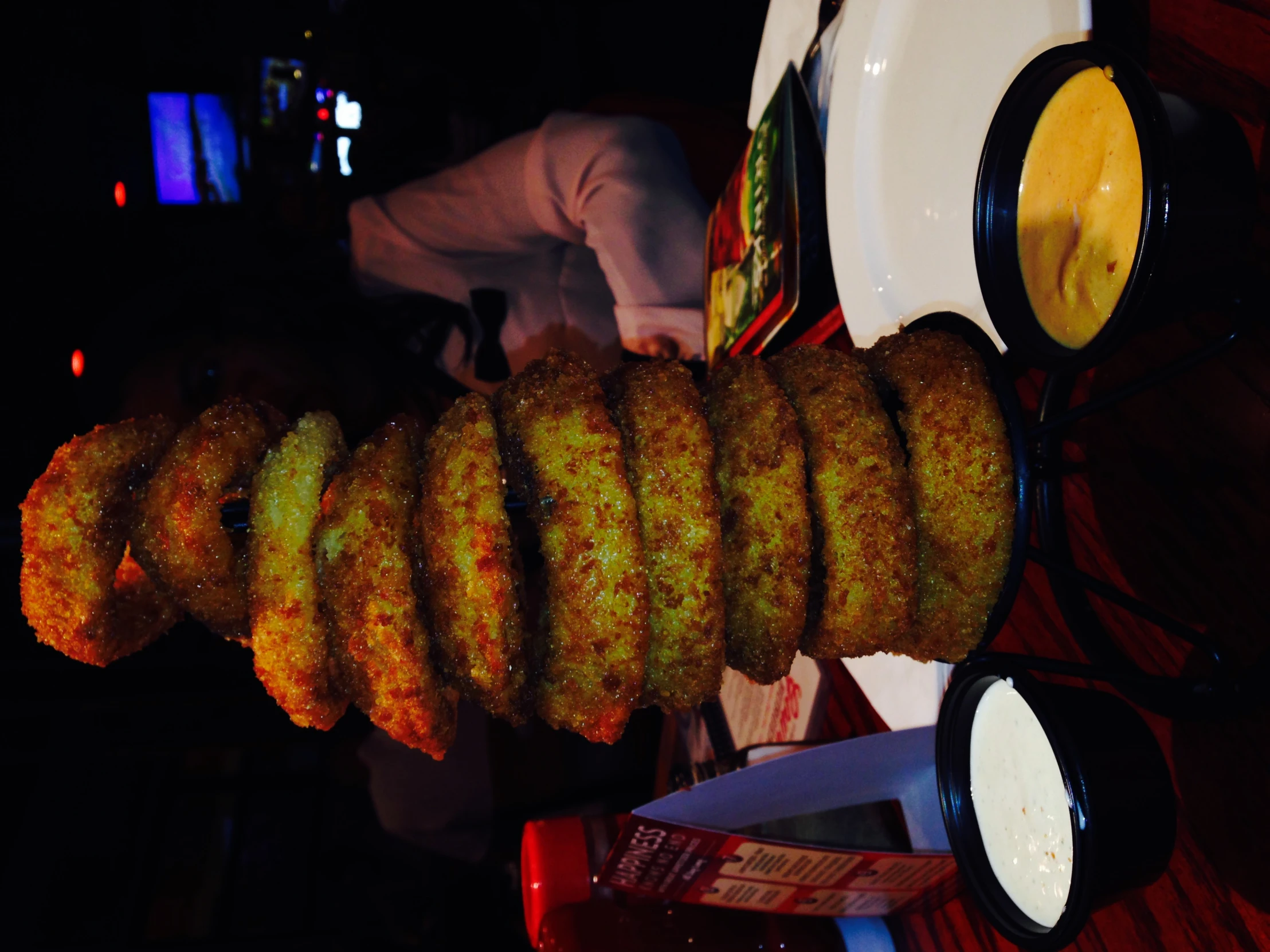 several stacks of donuts on a plate and bowls with sauce