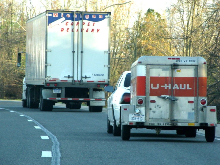 two trucks travelling on the road beside each other