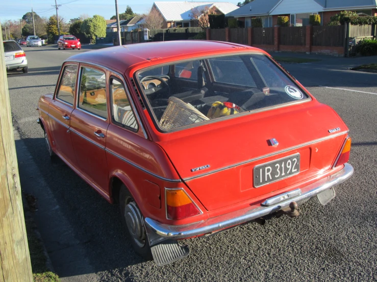 this old car is parked next to a street sign