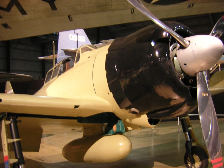 a small yellow airplane sits on display