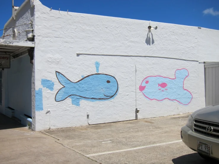 a wall painted with two fish on it