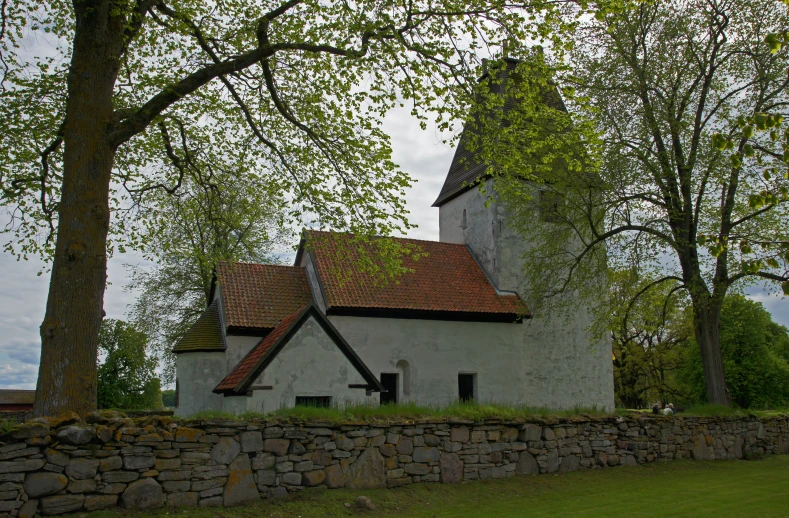 an old church on a hill in a town