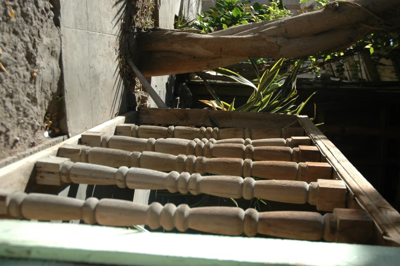 looking down the wooden stairs that lead up to an outdoor porch