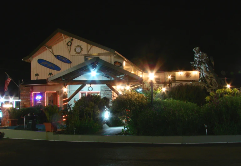 a lighted entrance and building are seen at night