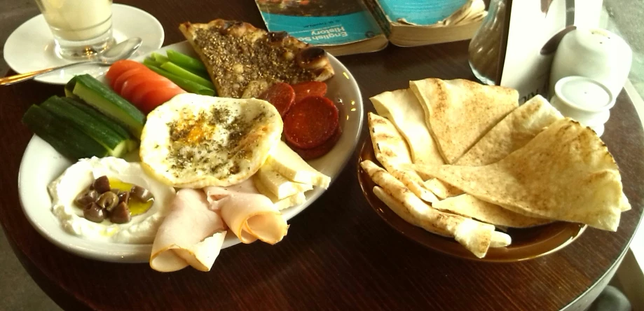 a plate with meat, vegetables and an egg salad