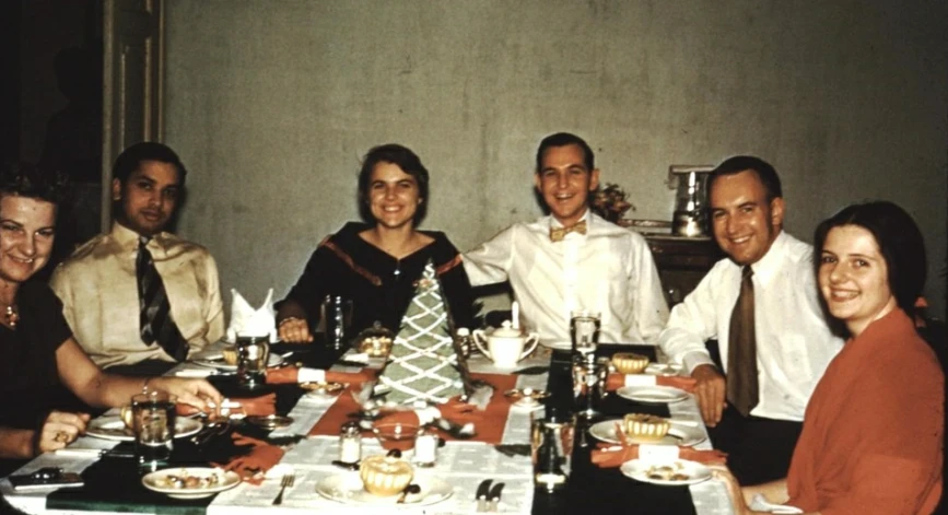 a group of friends that are sitting at a table