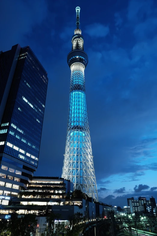 the large lighted tower is lit up in blue