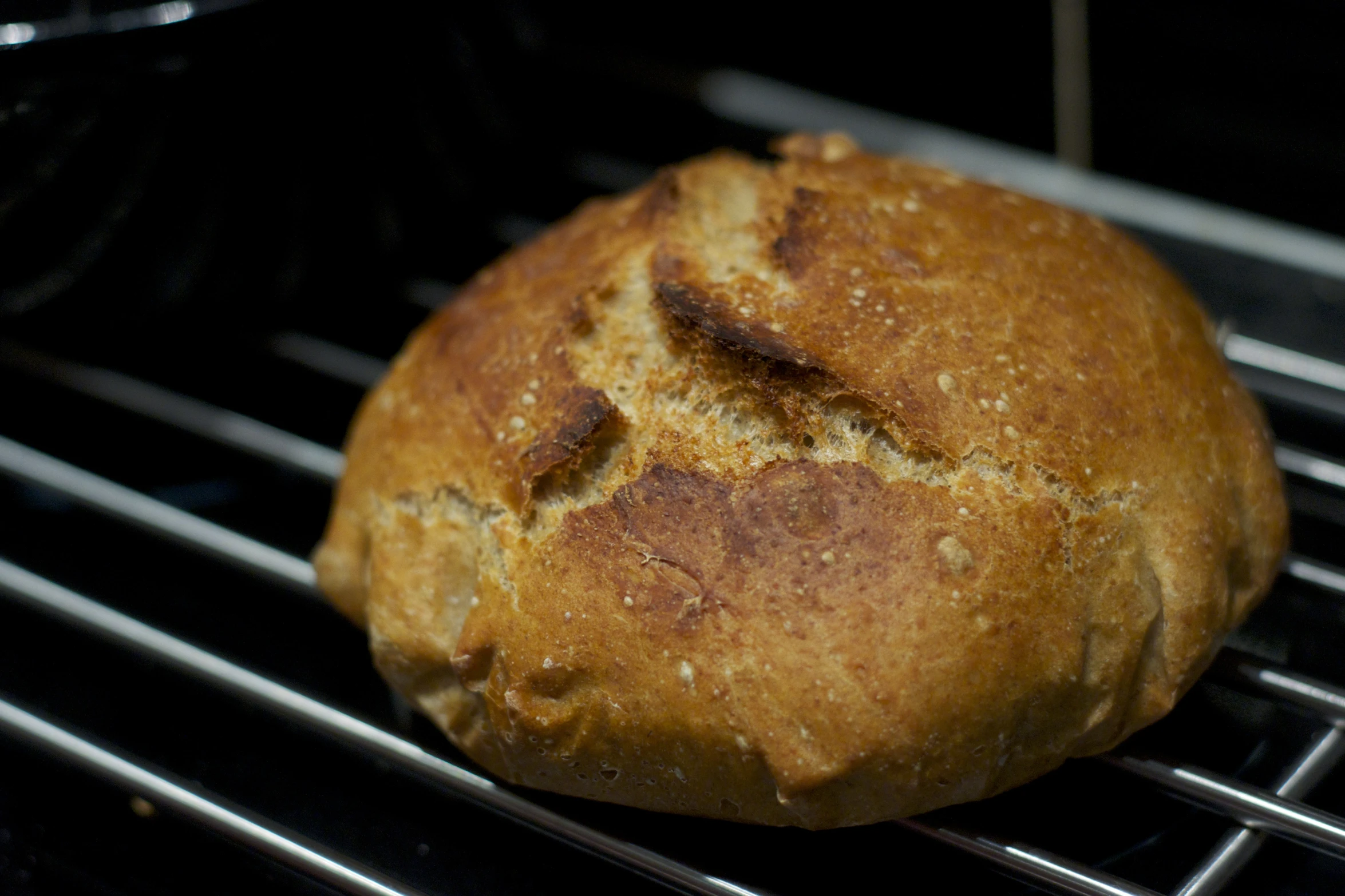 a loaf of bread sitting on top of a metal rack