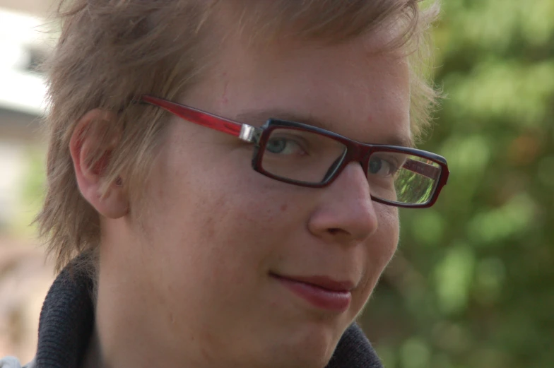 a person with glasses on is looking at the camera