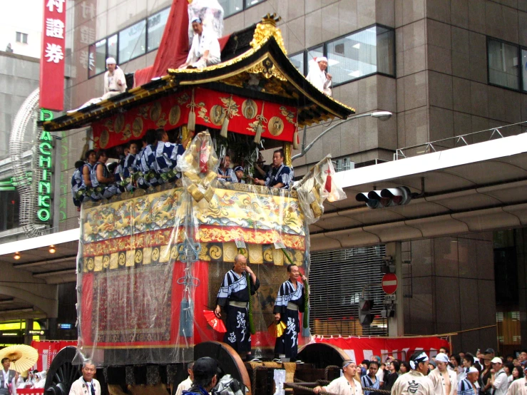 several men dressed in traditional asian garb, performing a chinese parade