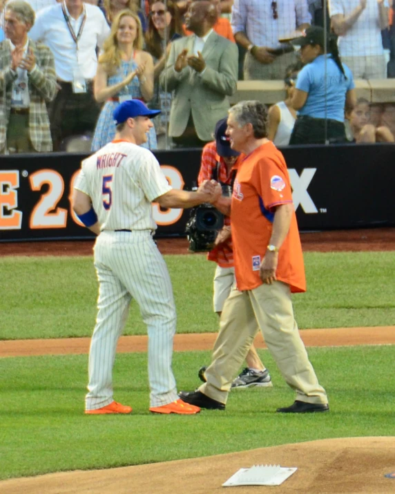 a group of men standing on a baseball field