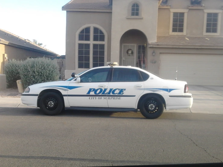 the police car is parked in front of the house