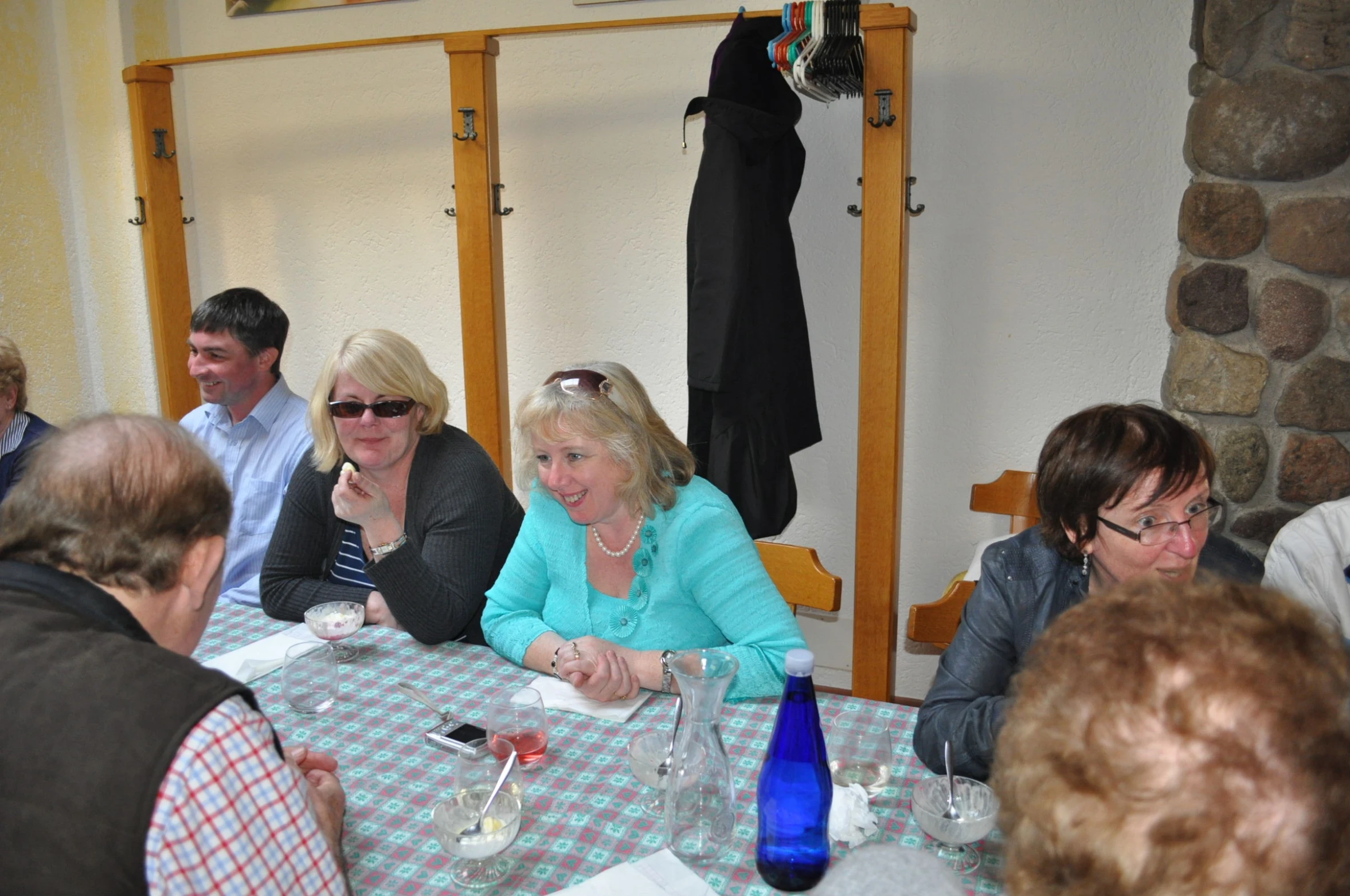 a group of people at a table with drinks and papers