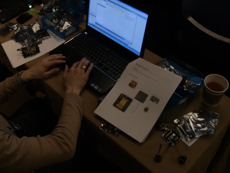 woman using laptop computer with blank screen displayed on desk