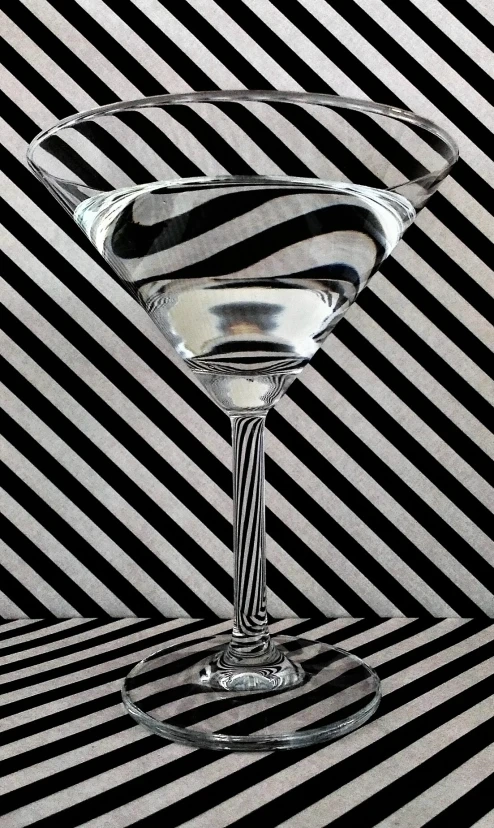 a drink glass on a diagonal black and white table