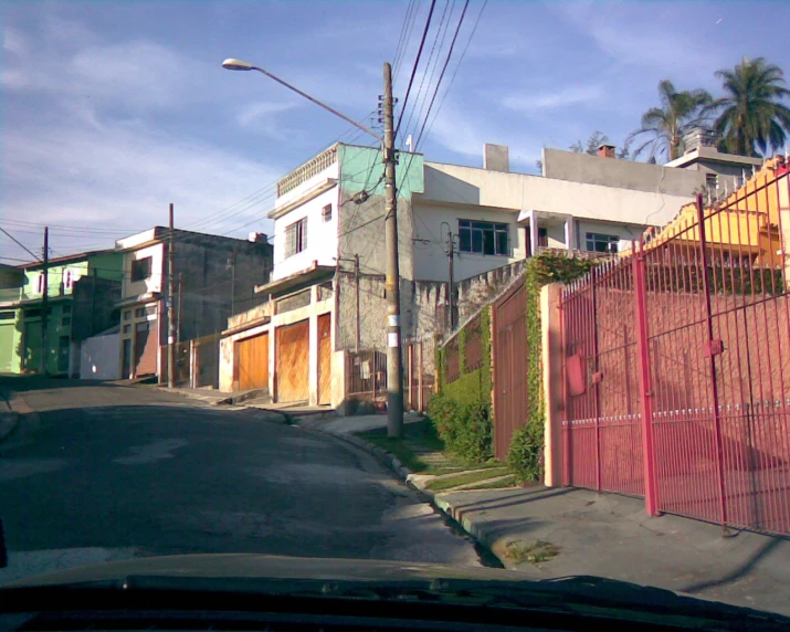 a street scene of a residential street with a few buildings in it